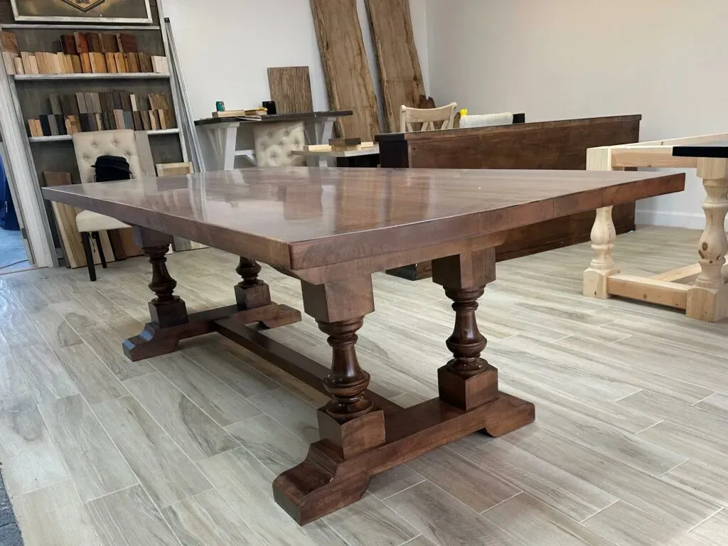 A grand statement piece with timeless elegance, The Oyster Hill Table features handcrafted pedestal legs and a rich, satin-smooth finish that anchors any dining space in classic Southern charm.