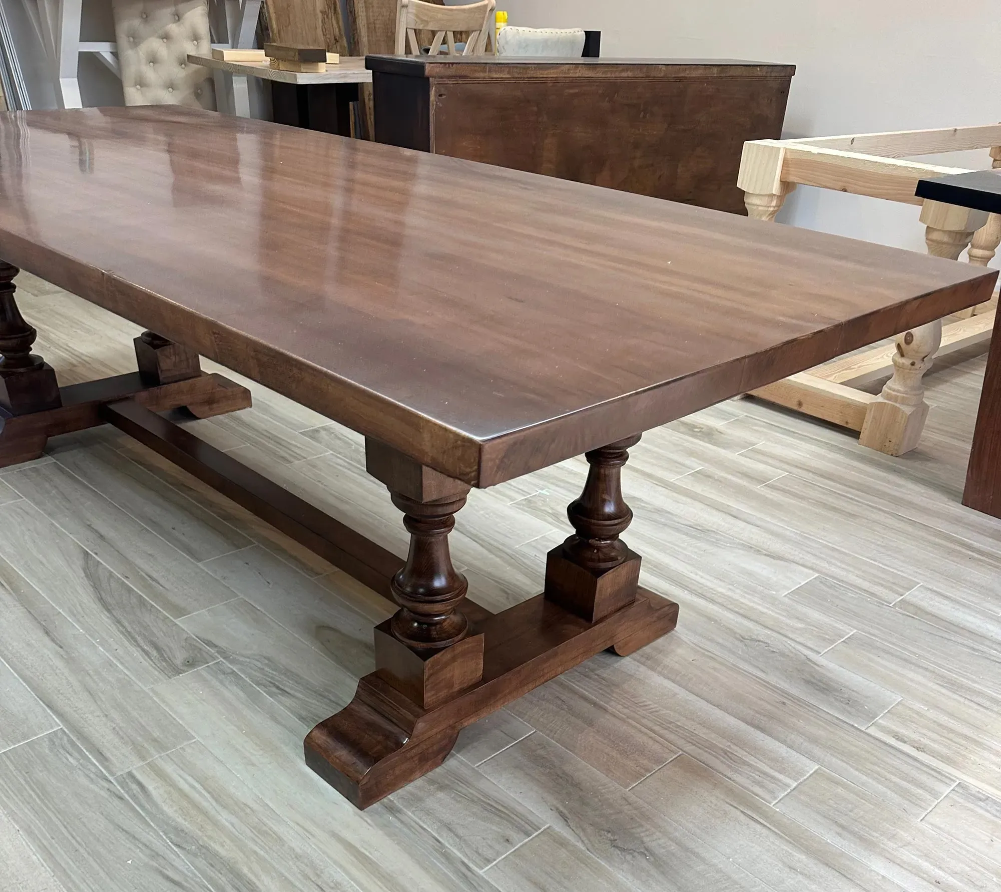 A grand statement piece with timeless elegance, The Oyster Hill Table features handcrafted pedestal legs and a rich, satin-smooth finish that anchors any dining space in classic Southern charm.